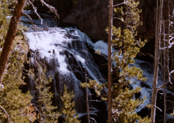 Smaller waterfall viewed through the tree branches